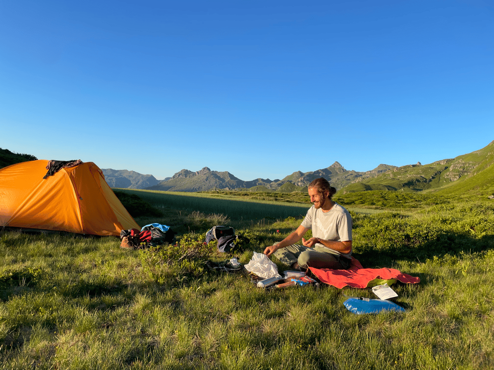 Kai in camping place, mountains in the background